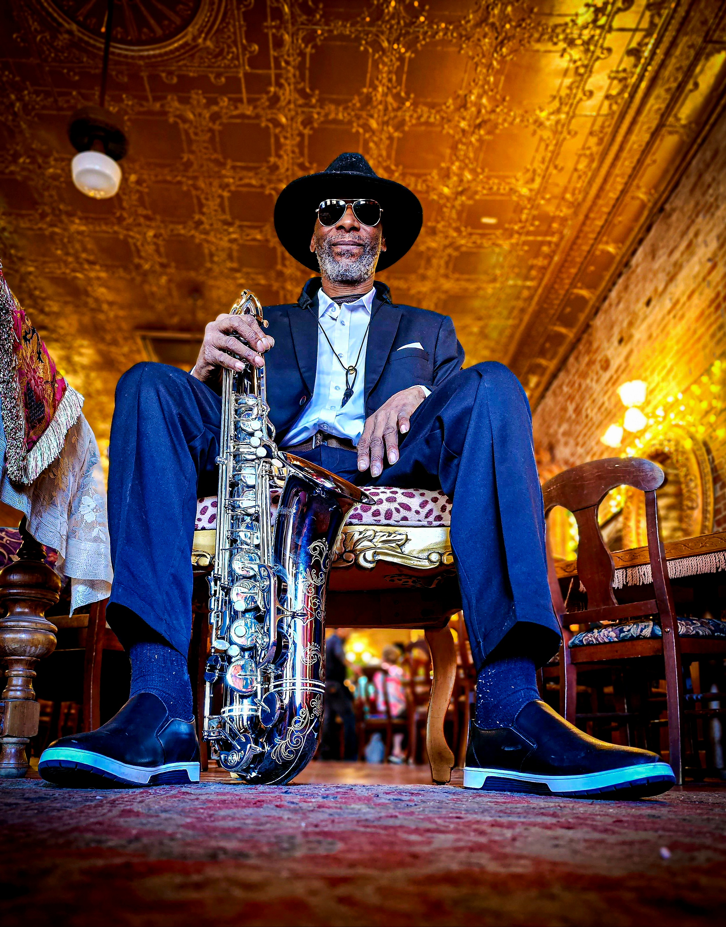 A musician sitting peacefully in a chair near a window, reflecting creativity and focus