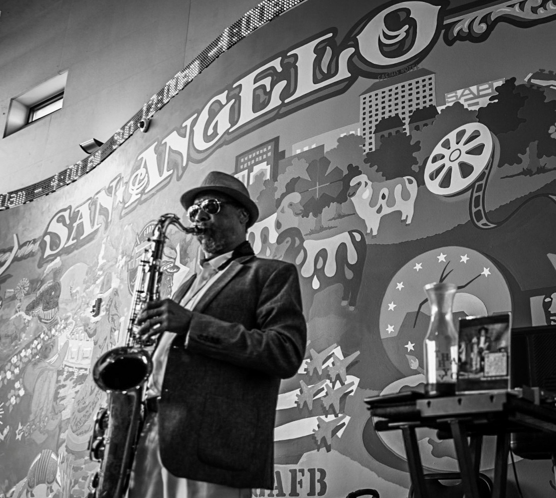 Musician working in an accessible home studio environment using audio production tools